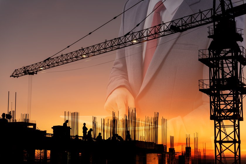 Construction site at sunset with tower crane